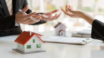 Real estate business, sales representatives offer home purchase contracts to buy a house or...