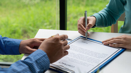 human hand working with documents at close-up table signature document Emphasis on female hand pen, sign official documents, contact subscribe name in declaration with legal value, contract management