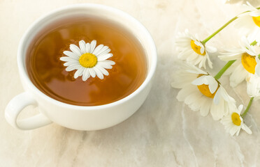 cup of chamomile tea with chamomile flowers. Healthy eating