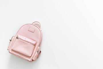 Elegant leather pink female backpack isolated on white with copy space. Back to school concept
