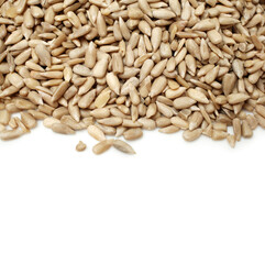 Peeled sunflower seeds pile on white background