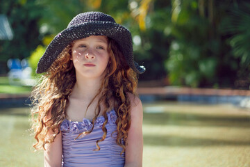 Portait of girl wearing a sunhat in Summer