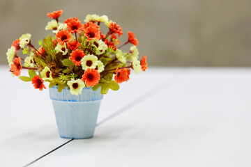 A vase of fake flowers for decoration with copy space