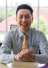Close up shot of Asia short black hair male handsome success businessman smile and sitting alone...