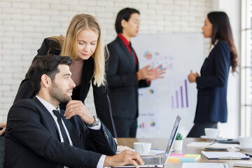A group of diverse businesspeople working together in a modern office in an intimate manner. Idea for teamwork and good business colleagues