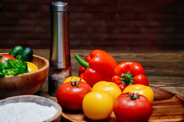 a wooden bowl of flour, spices and vegetables on the kitchen table