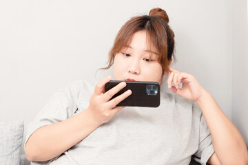 Asian fat girl sitting on the sofa