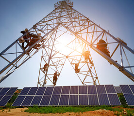 A worker at the solar panels and electric tower maintenance