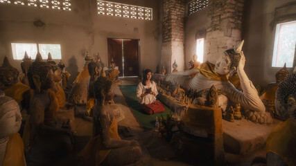 a woman praying in an ancient thailand temple , at " Wat Samret" Koh samui ,Suratthani	