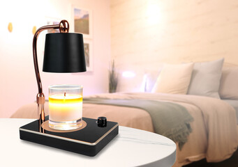 The luxury lighting aromatic scent glass candle is put on the electric lamp candle warmer heater on...