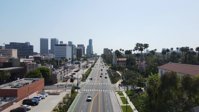 Aerial View, Daily Traffic, Santa Monica Boulevard in Beverly Hills, Los Angeles Sunny California USA, Pull Back Drone Shot