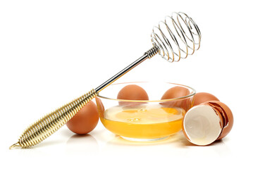 Wire whisk and brown eggs on white background 