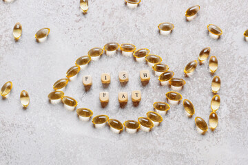 Composition with fish oil pills on grunge background