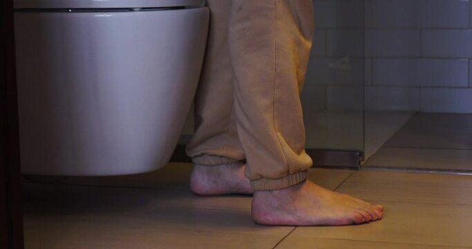 A woman goes to the toilet and sits on the toilet.The process of defecation. Toilet at home. Healthy bowel movements in the morning.