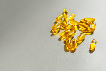 Fish oil capsules on grey background