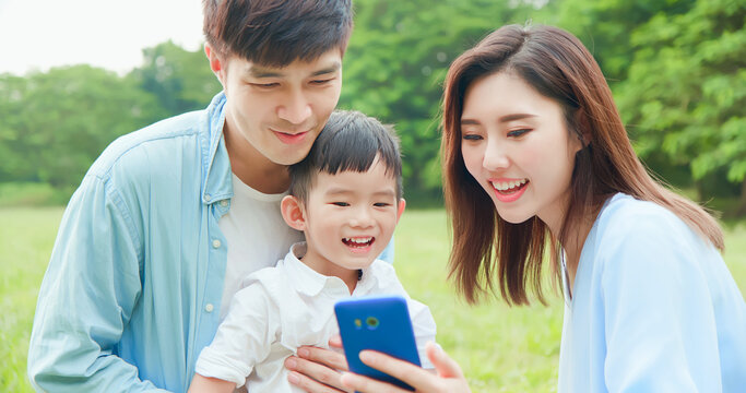 Parent and kid look smartphone