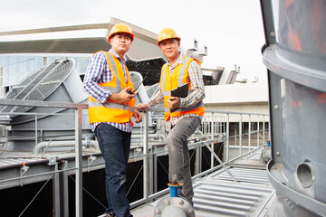 Asian engineer refrigeration plant  factory. male mechanic wearing helmet and Reflective Safety...