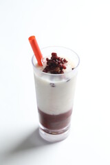 ice cold chilled fresh sweet coconut milk soya drink with red bean paste and red straw beverage menu in white background