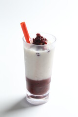 ice cold chilled fresh sweet coconut milk soya drink with red bean paste and red straw beverage menu in white background