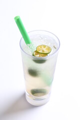 ice cold chilled fresh sour lime fruit honey drink in glass and green straw beverage menu in white background