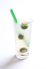 ice cold chilled fresh sour lime fruit honey drink in glass and green straw beverage menu in white background