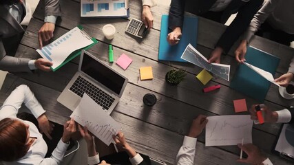 Diverse executive business people team discussing work results at meeting, multiracial businessmen talking analyzing financial statistics report sitting together in modern office with laptop and docum - Powered by Adobe