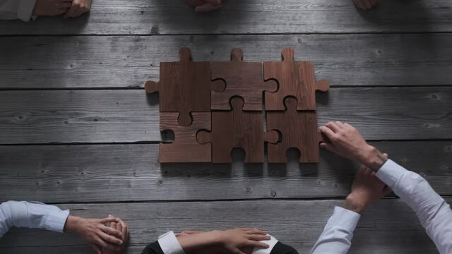 Business teamwork with puzzle finishing project cooperation unity concept