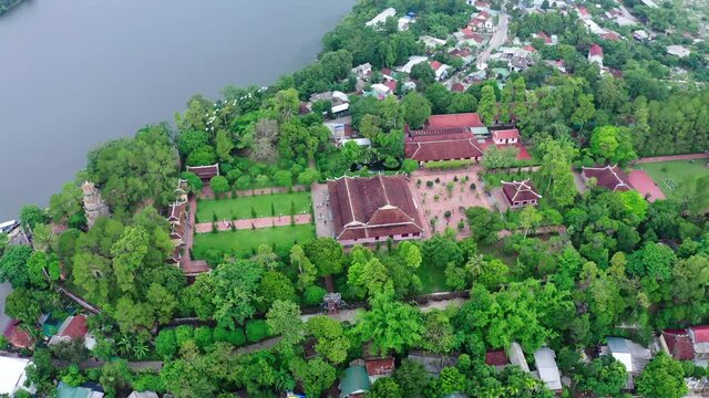 Aerial Shot Of Birds Flying Over Thien Mu Pagoda By Perfume River, Drone Panning Over Famous Buddhist Temple - Hue, Vietnam