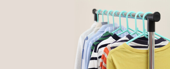 Pastel kid shirts hanging on rack in shop