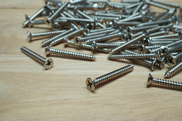 Metal screws on wooden table, Accessories material of the carpentry