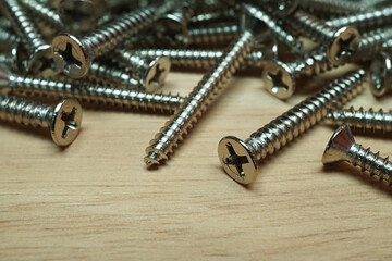 Metal screws on wooden table, Accessories material of the carpentry