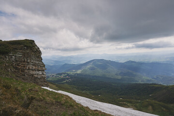 Snow in the mountains in summer. Sunny day in the mountains. Ukrainian Carpathian mountains.