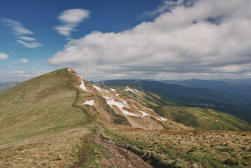 Snow in the mountains in summer. Sunny day in the mountains. Ukrainian Carpathian mountains.