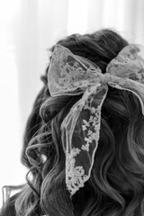 White bow woven into women's curls