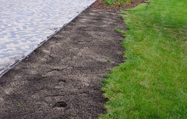 repair of damaged lawns after installation of automatic irrigation. bringing piles of soil and...