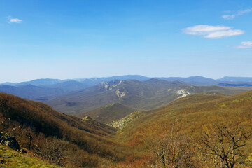 Mountains landscape against blue sky with clouds on sunny day