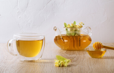 cup of herbal tea with linden flowers and honey