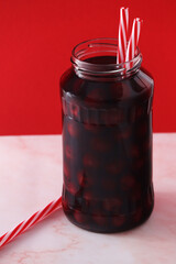 Cherry compote in a glass jar