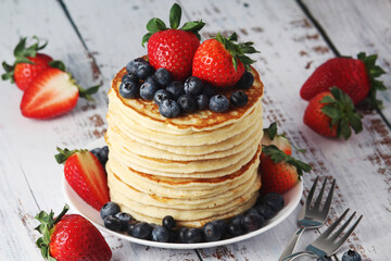 A stack if home-made pancakes with berry