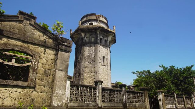 Lighthouse on a hill near the sea. Lighthouse in cape Engano against blue sky, province of Cagayan, Philippines.