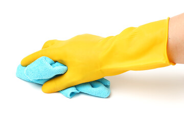 Closeup of a hand in a yellow latex glove using a blue towel to clean a counter top. 