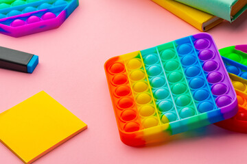 Colorful antistress pop it toy on pink background
