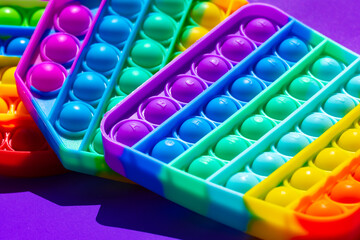 Colorful antistress pop it toy on purple background