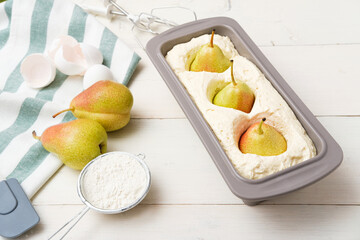 process of preparation pie with whole pears on white background, pound pear cake