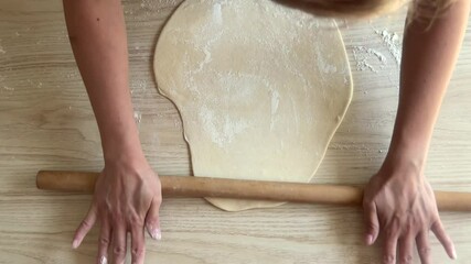 Woman preparing dough for homemade pizza