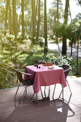 Table for two with wine glasses in a natural outdoor setting, COVID-secure concept