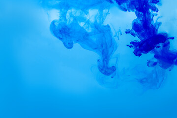 Beautiful colorful background with glitter and blue colored oil bubbles and watercolor. Sparkle particles. Macro oil ink bubbles and drops. Abstract template mixed texture. Colored wallpaper, pattern.