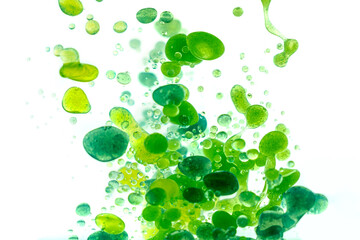 Blue and green paint drops in oil.  Macro shot, abstract background with ink and water. Bubbles...