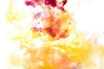 Bright pink and yellow acrylic paint swirling in water. Ink moving in liquid creating abstract clouds. Traces of colorful dissolving in water, changing shape. Abstract decorative creative background.