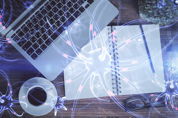 Neuron hologram drawings over computer on the desktop background. Top view. Multi exposure. Concept of education.
